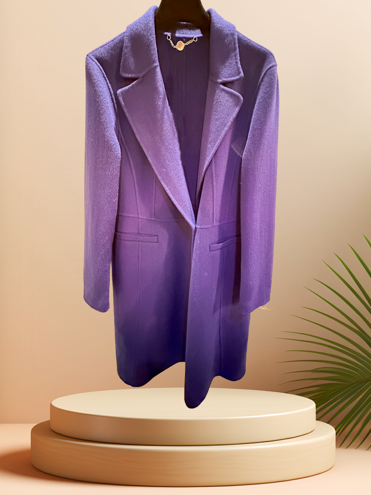 Marccain royal blue long coat displayed on a pedestal, highlighting its premium wool fabric and stylish design.