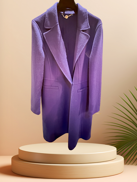 Marccain royal blue long coat displayed on a pedestal, highlighting its premium wool fabric and stylish design.