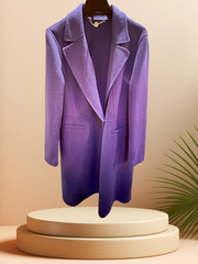 Marccain royal blue long coat displayed on a pedestal, highlighting its premium wool fabric and stylish design.