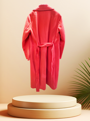 Marccain coral red long coat made of wool and cashmere, stylishly displayed with a minimalistic background.