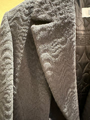 Close-up of the luxurious Laurel Black Long Coat featuring a wavy pattern and elegant mandarin collar.