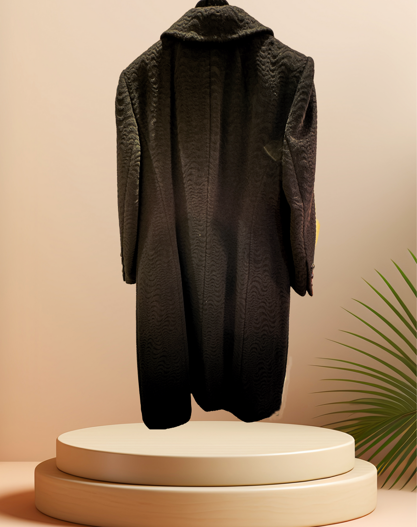 Elegant Laurel Black Long Coat showcasing wavy pattern and mandarin collar, displayed on a pedestal with greenery.