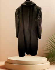 Elegant Laurel Black Long Coat showcasing wavy pattern and mandarin collar, displayed on a pedestal with greenery.