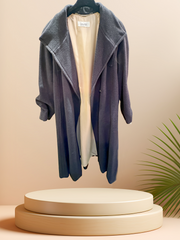 Laurel Gray Long Coat displayed on a podium, showcasing its elegant design and lightweight fabric.