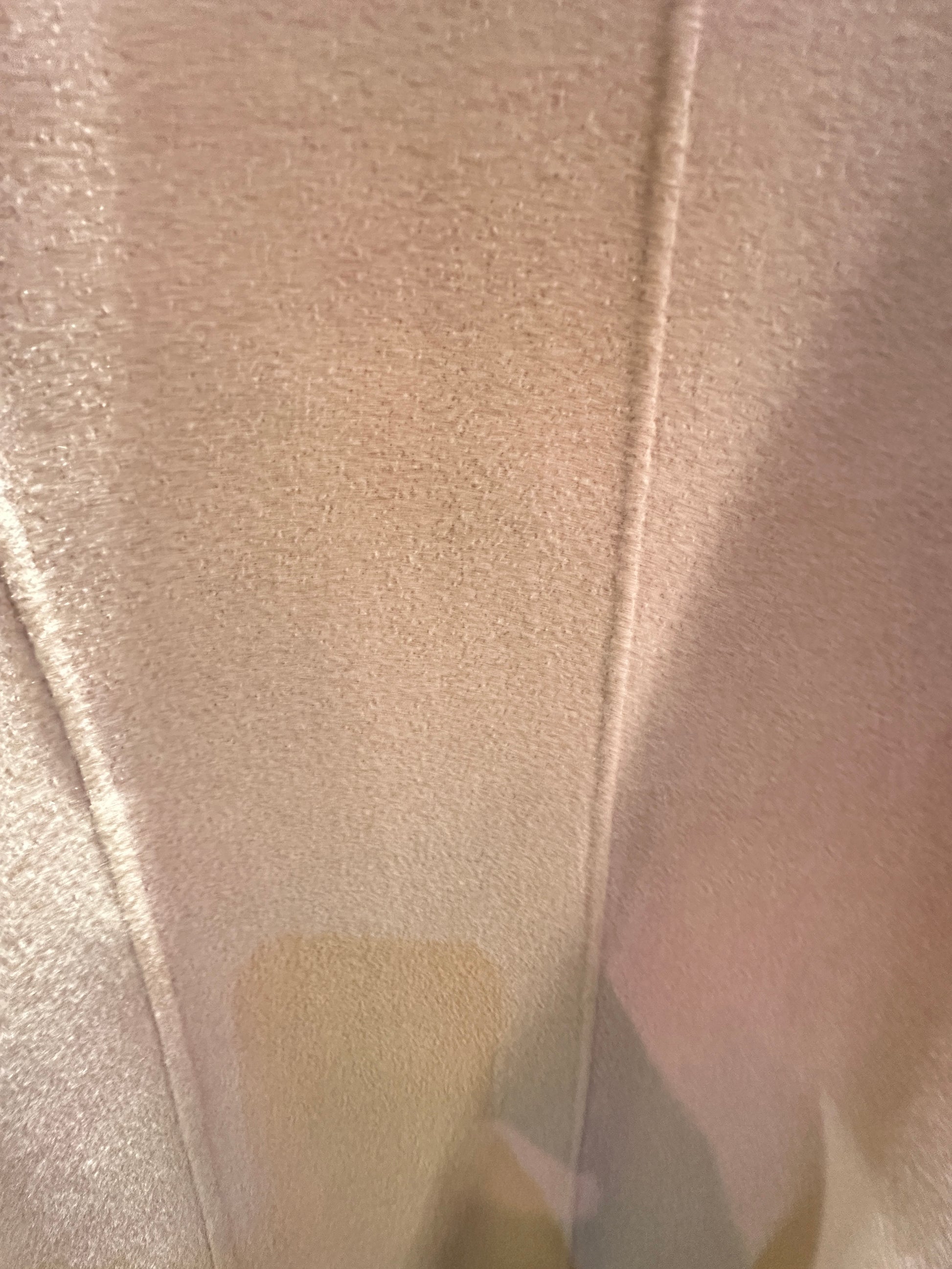 Close-up view of the luxurious fabric of the Marccain Wheat Long Coat, showcasing its soft texture and warmth.