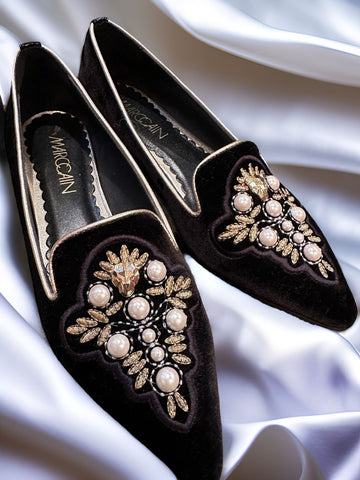 Marccain black slip-on flats with pearl and golden thread decoration on elegant fabric.