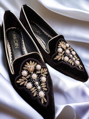 Marccain black slip-on flats with pearl and golden thread decoration on elegant fabric.