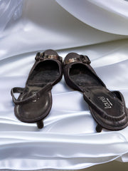 Laurèl black mules heel featured on elegant white satin background, showcasing unique bow decor and stylish design.