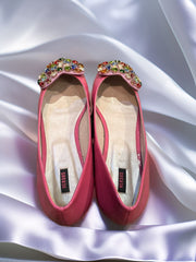 Versus Ballerina Flat in pink with jeweled decoration on a silky background, showcasing elegance and comfort.
