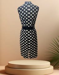 Back view of a stylish Michael Kors black and white polka-dot dress on a display with a modern aesthetic.