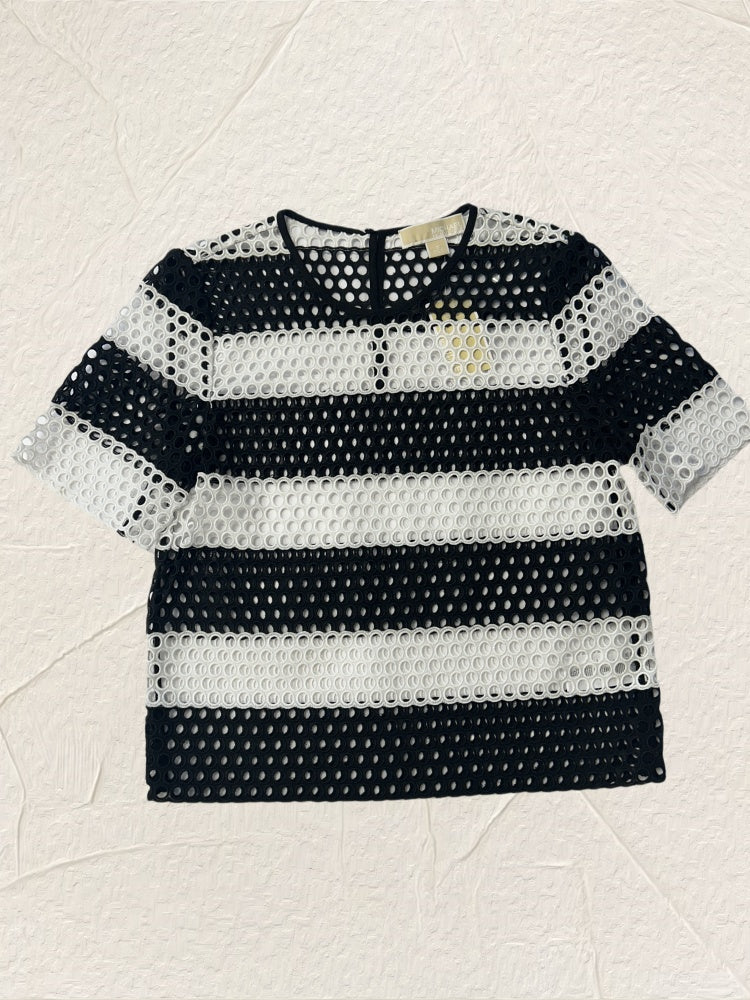 Michael Kors black and white blouse featuring a trendy perforated design, perfect for summer style.