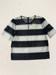 Michael Kors black and white blouse featuring a trendy perforated design, perfect for summer style.