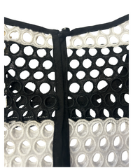 Close-up of the back zipper detail on the Michael Kors black and white breeze blouse featuring a unique cutout design.