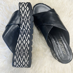 Marccain black leather platform flip flops with a stylish patterned wedge sole, perfect for summer outfits.