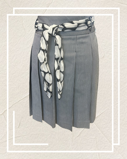 Ambiente A-line Skirt featuring thin black and white stripes and a polka dot scarf at the waist, perfect for any occasion.