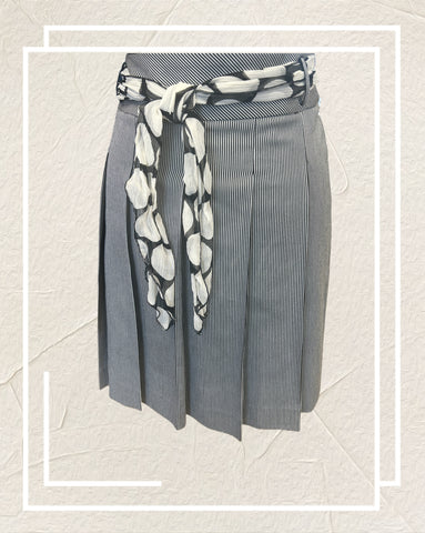 Ambiente A-line Skirt featuring thin black and white stripes and a polka dot scarf at the waist, perfect for any occasion.