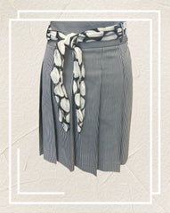 Ambiente A-line Skirt featuring thin black and white stripes and a polka dot scarf at the waist, perfect for any occasion.