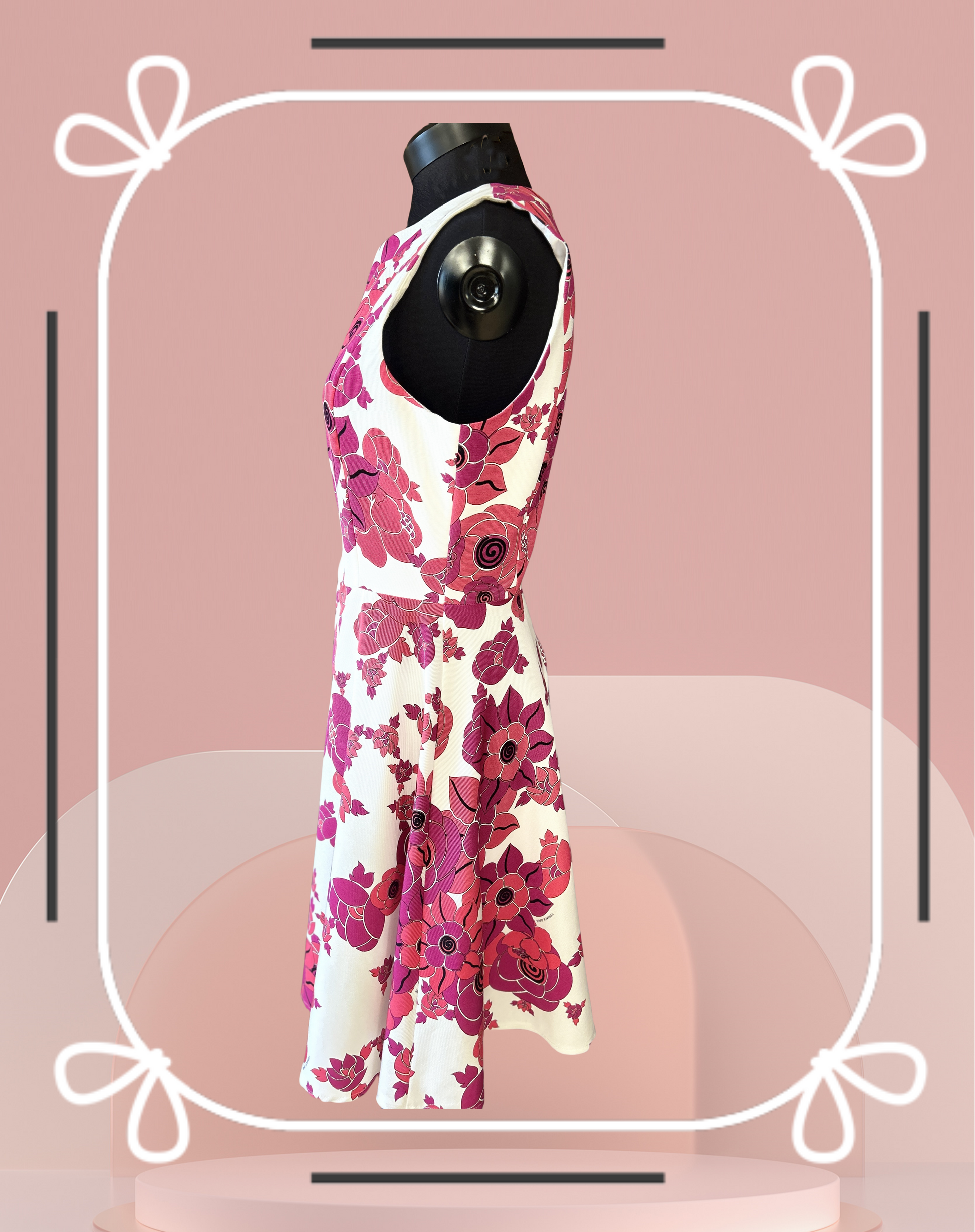 Versace white and red floral dress showcased on a mannequin, perfect for summer occasions.