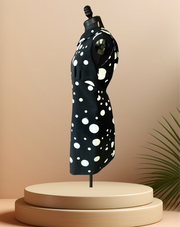 Versace black and white polka dot dress on mannequin, showcasing its stylish design and print.