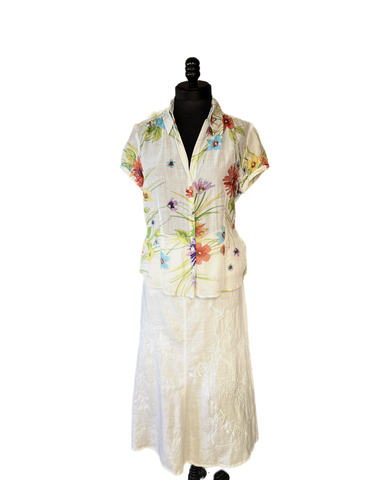 Gerard Darel long white linen skirt paired with a floral short-sleeve shirt, showcasing summer style and comfort.
