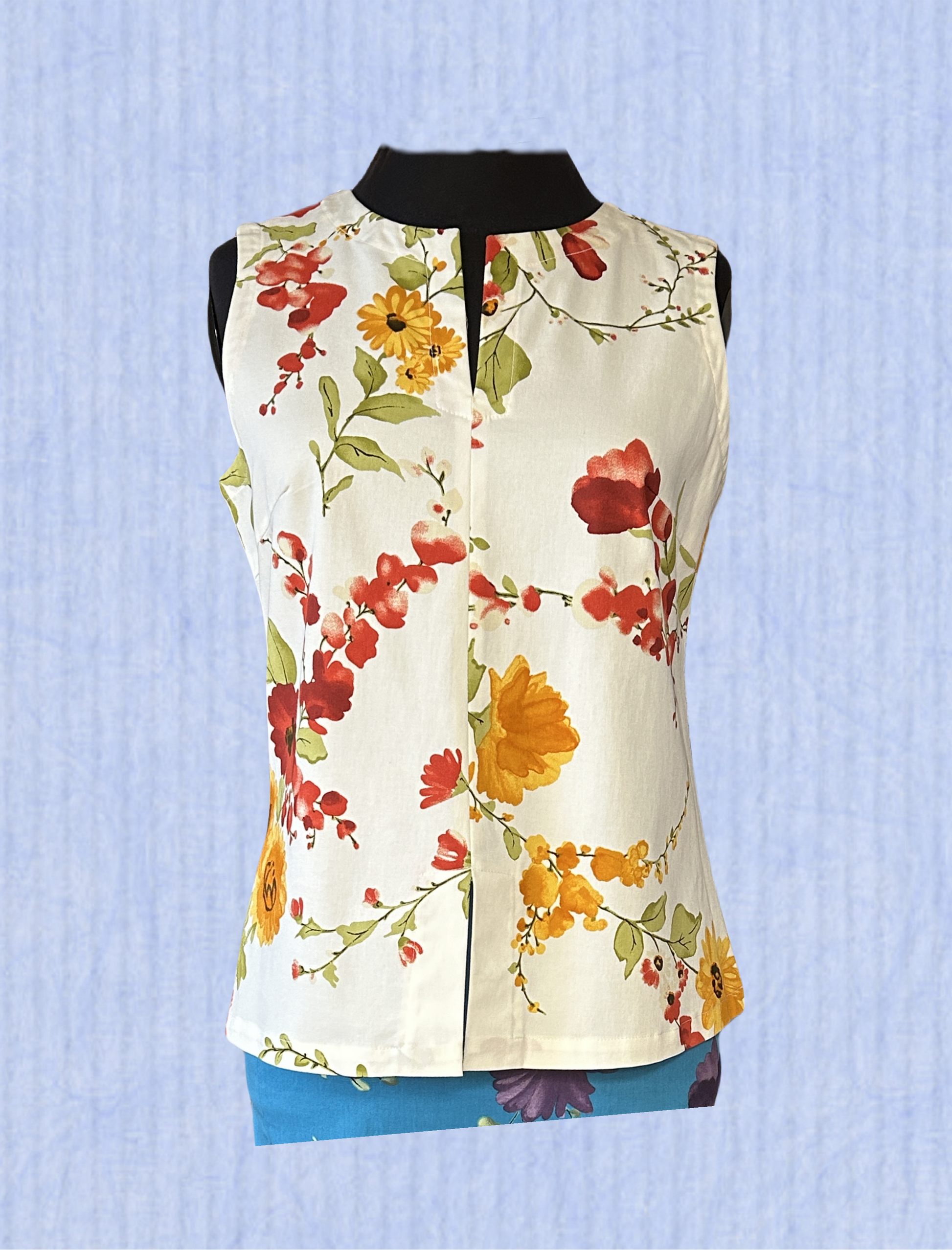 Derrico White Floral Blouse featuring a vibrant floral pattern, perfect for stylish and comfortable wear on any occasion.