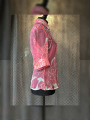 Side view of a pink Versace silk shirt with floral design, showcasing its elegant fitted cut.