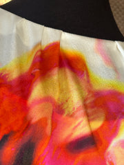 Close-up of Marccain silk blouse with vibrant red and orange floral print, showcasing silky texture and elegance.