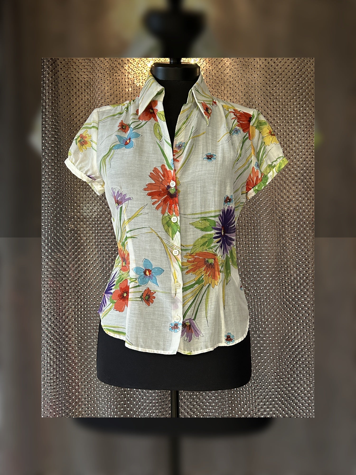Escada silk shirt featuring a vibrant floral design perfect for summer, combining comfort and elegance.