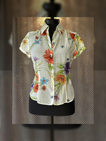 Escada silk shirt featuring a vibrant floral design perfect for summer, combining comfort and elegance.