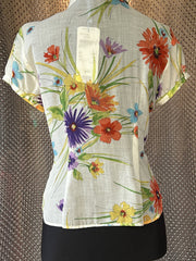 Back view of Escada floral silk shirt, showcasing vibrant flowers on a light fabric, perfect for summer elegance.