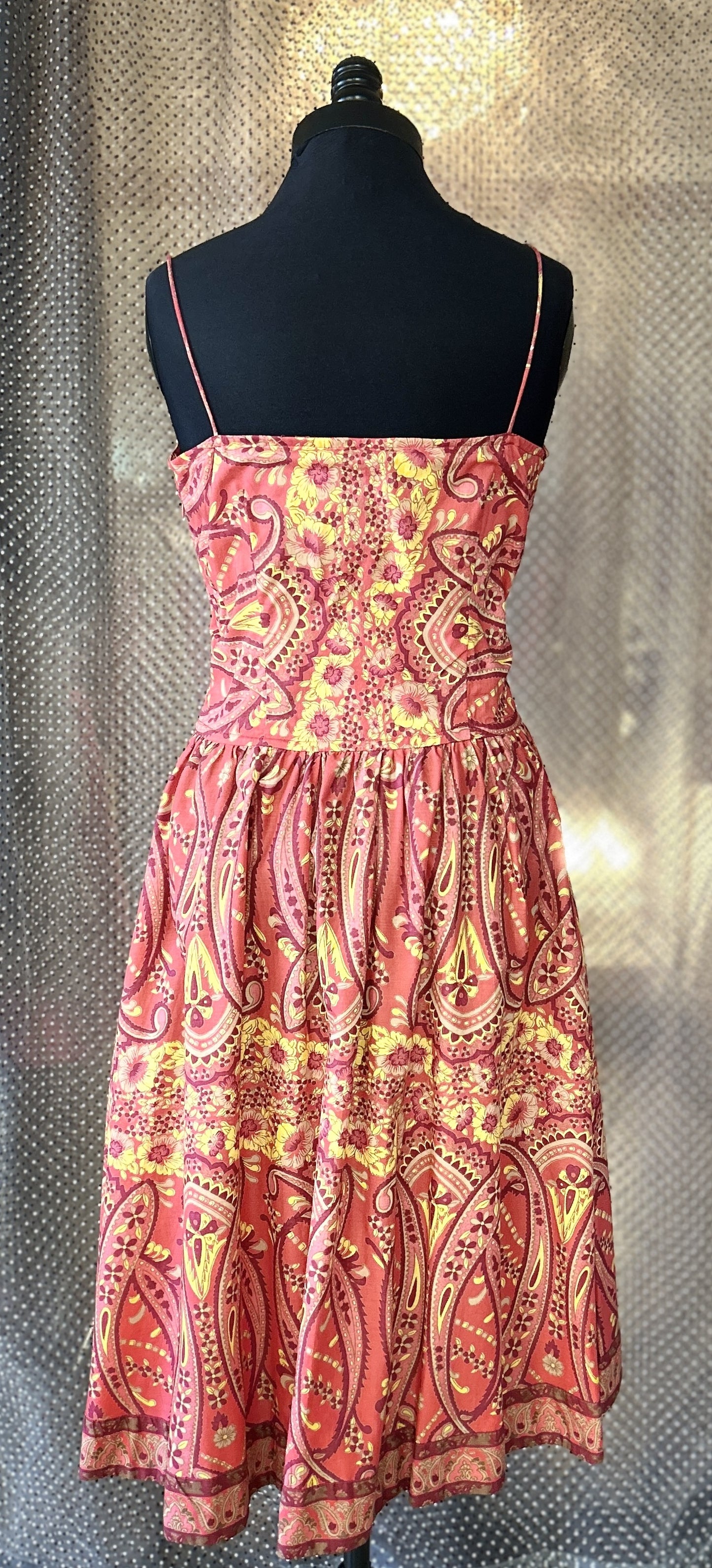 Back view of a #Plenty# Summer Dress in vibrant burgundy and yellow floral print, made of 100% cotton.