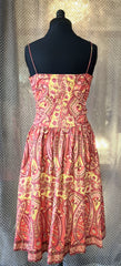 Back view of a #Plenty# Summer Dress in vibrant burgundy and yellow floral print, made of 100% cotton.