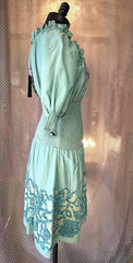 Side view of a mint green dress showcasing intricate embroidery and a stylish design, perfect for any wardrobe.