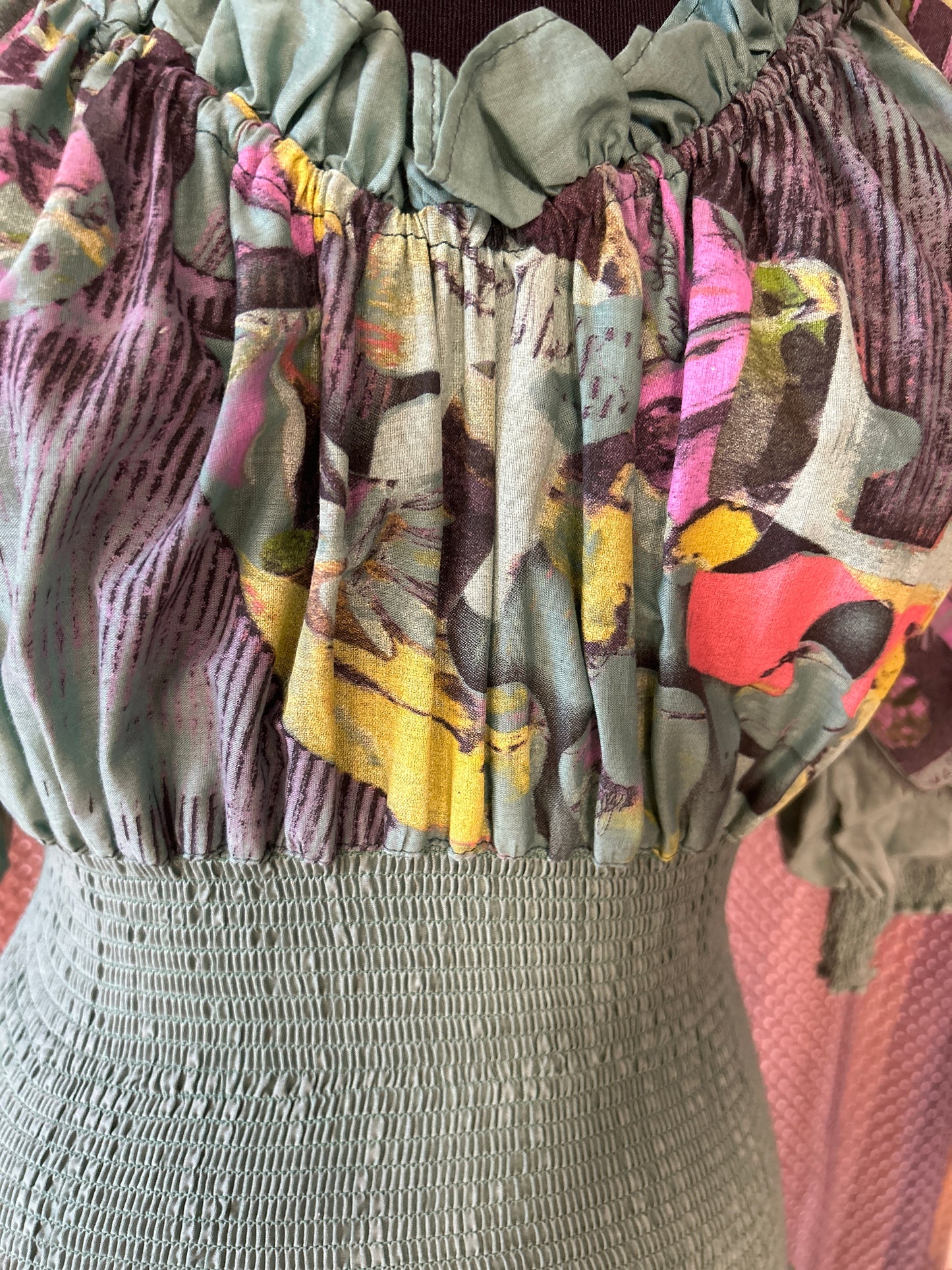 Close-up of the Save The Queen green dress showcasing its unique floral pattern and textured bodice.