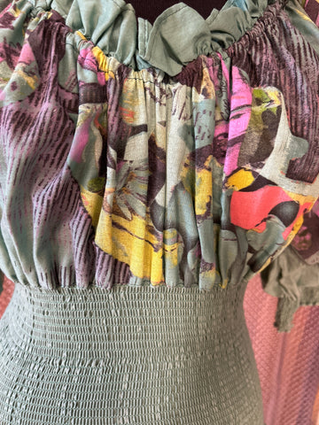 Close-up of the Save The Queen green dress showcasing its unique floral pattern and textured bodice.