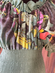 Close-up of the Save The Queen green dress showcasing its unique floral pattern and textured bodice.