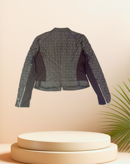 Back view of a stylish Michael Kors Leather Jacket showcasing quilted design and silver nail decorations.