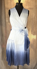 Marccain blue silk dress featuring a flattering wrap design and gradient ocean-inspired color for summer elegance.