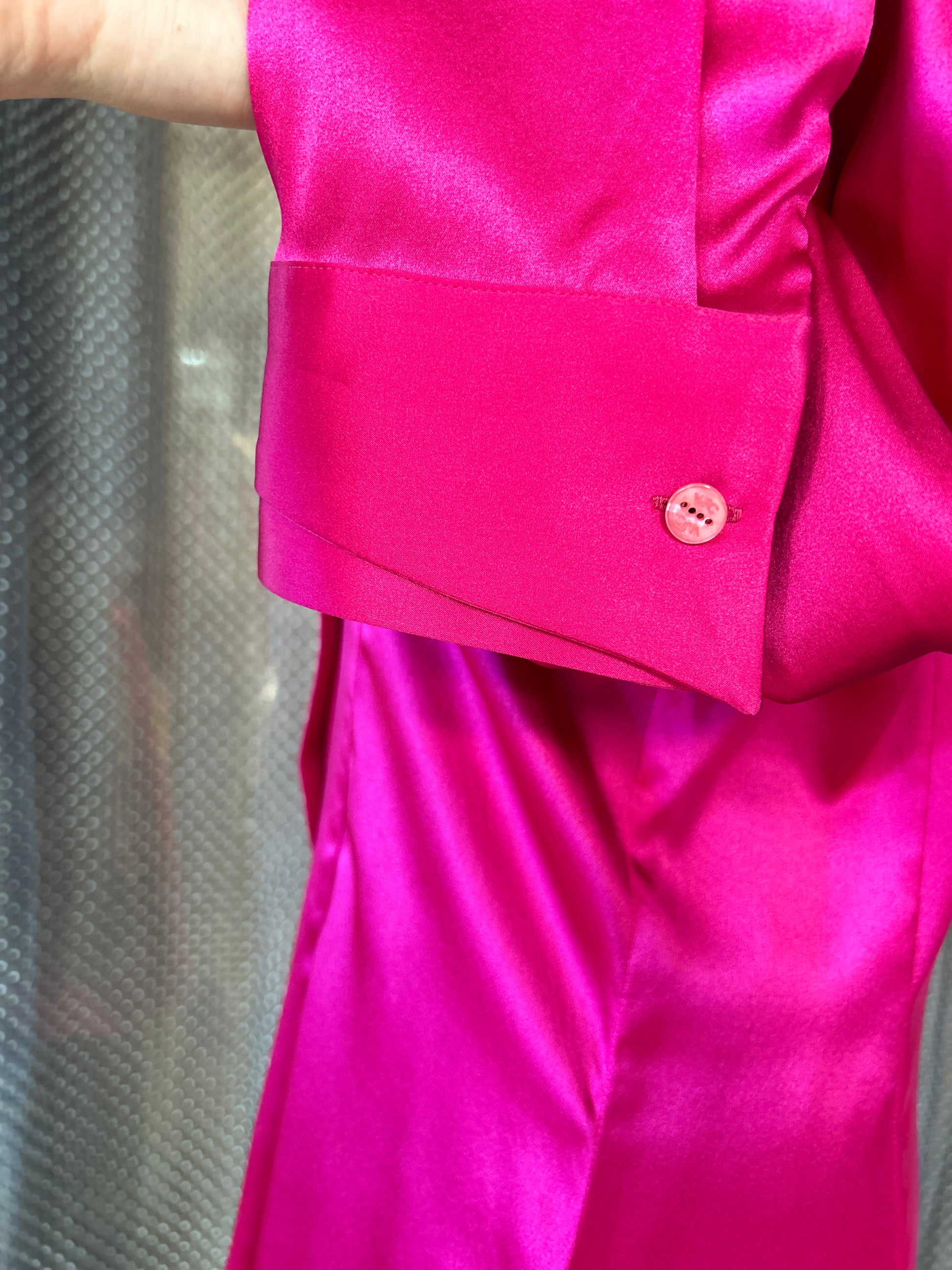 Close-up of the cuff and button detail of a luxurious Versace Silk Hard Pink Shirt.