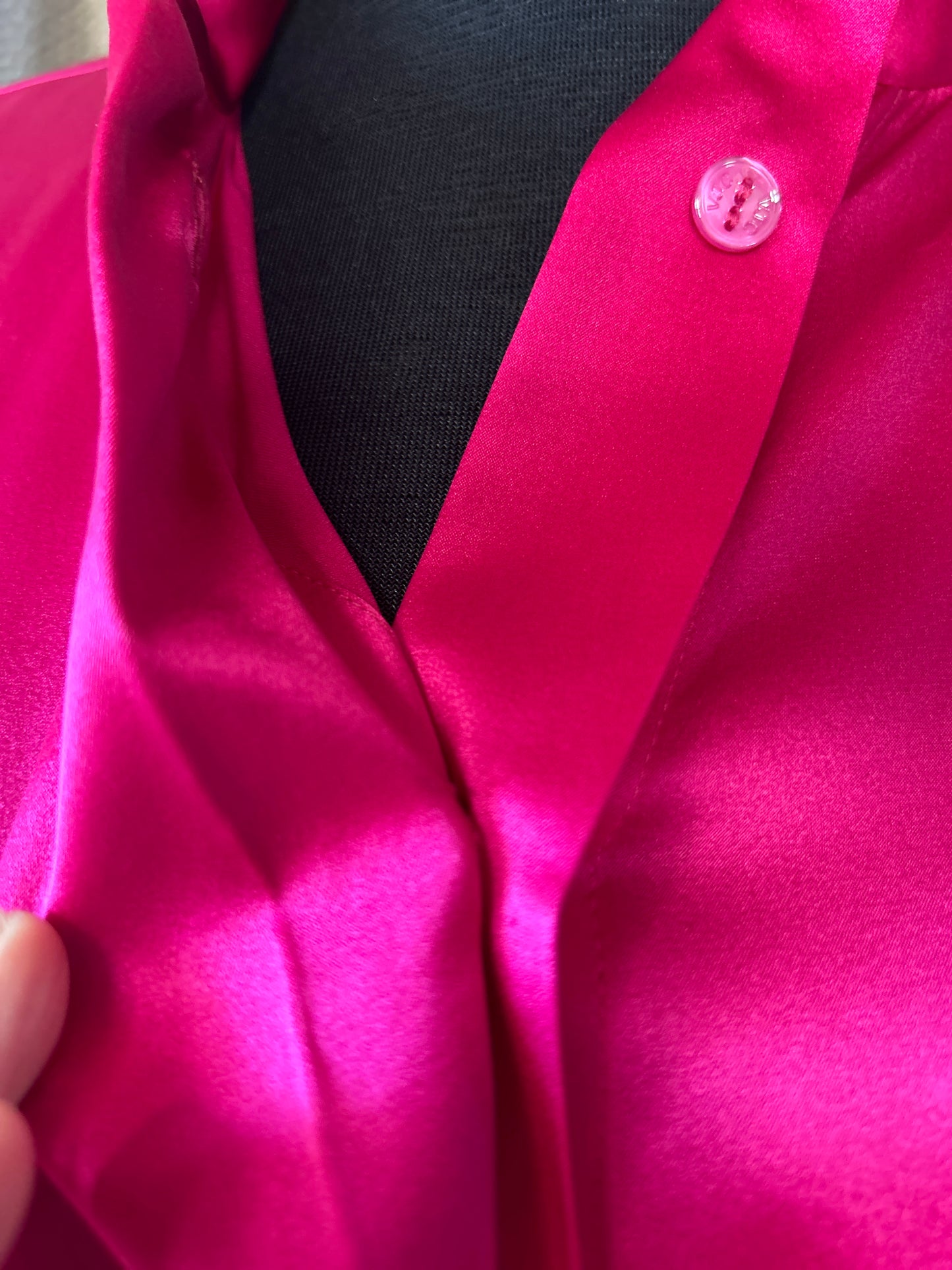 Close-up of Versace Silk Hard Pink Shirt showing luxurious silk fabric and elegant hidden buttons.