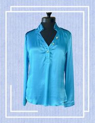 Versace silk shirt in blue displayed on a mannequin, showcasing luxurious fabric and elegant design.