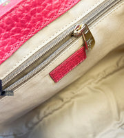 Interior close-up of a Versace Leather Bag showcasing the zippered compartment and vibrant pink accents.
