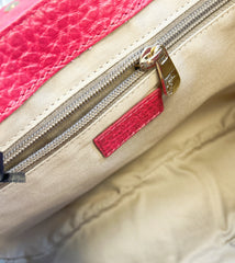Interior close-up of a Versace Leather Bag showcasing the zippered compartment and vibrant pink accents.