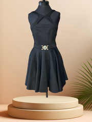 Versace black dress featuring a low cut back, strip sleeves, and circular skirt on a mannequin display.