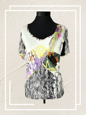 Save the Queen Blouse with abstract art print on a mannequin, showcasing style and comfort.