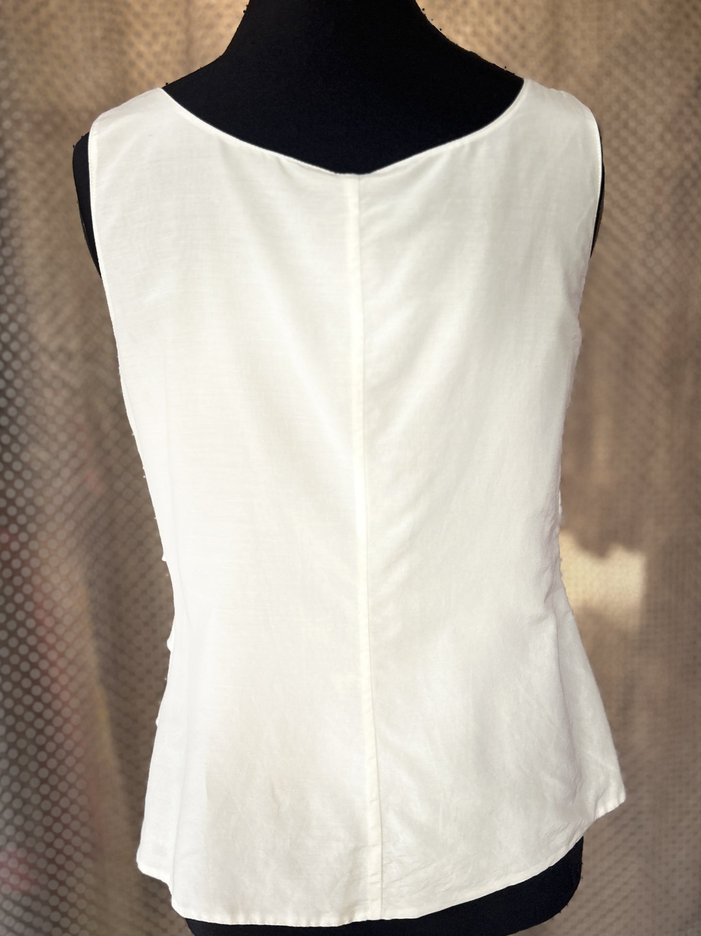 Back view of Marccain white blouse showcasing its tiered design and lightweight fabric for a stylish summer look.