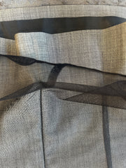 Close-up of textured gray wool fabric layered with black net, showcasing the materials used in the Laurel Vest.