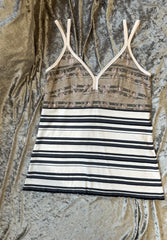 Marccain spaghetti strap vest with striped pattern and lace detail, featuring adjustable straps for a tailored fit.