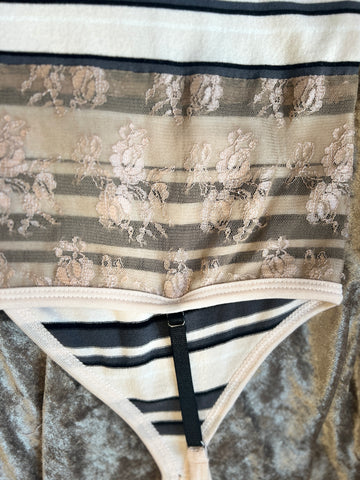 Close-up of Marccain spaghetti strap vest showcasing striped pattern and delicate lace detail for a feminine touch.