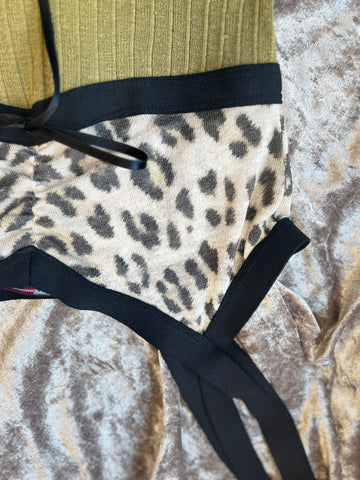 Marccain Spaghetti Strap Vest featuring an olive green ribbed texture and leopard print fabric for a trendy summer look.